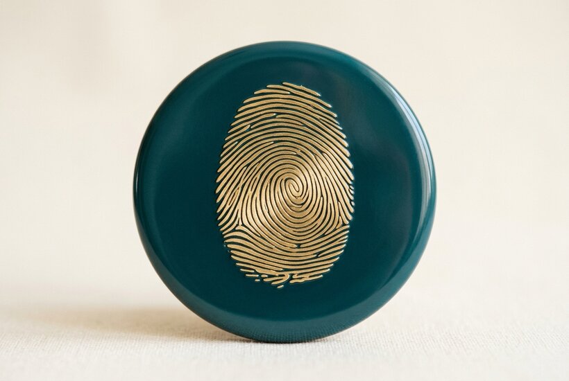 A single teal sphere with a gold orbit ring.