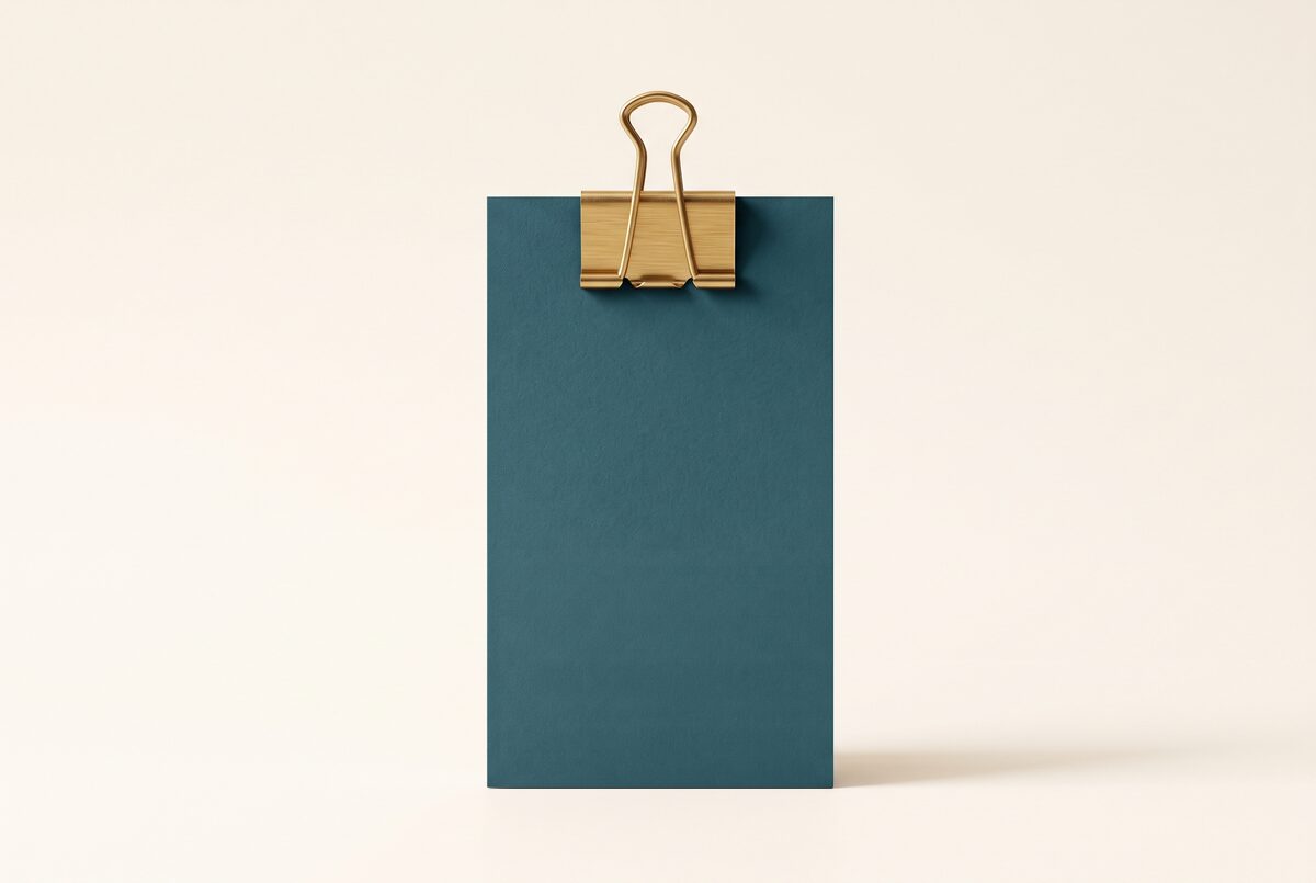 A matte teal card held by a brushed-gold binder clip: related items collected into a live list.